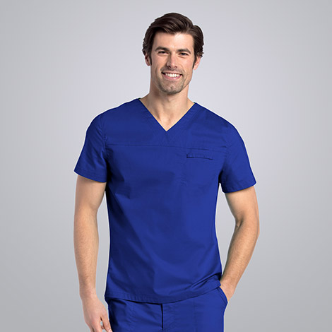 Male nurse smiling and wearing blue Landau scrubs