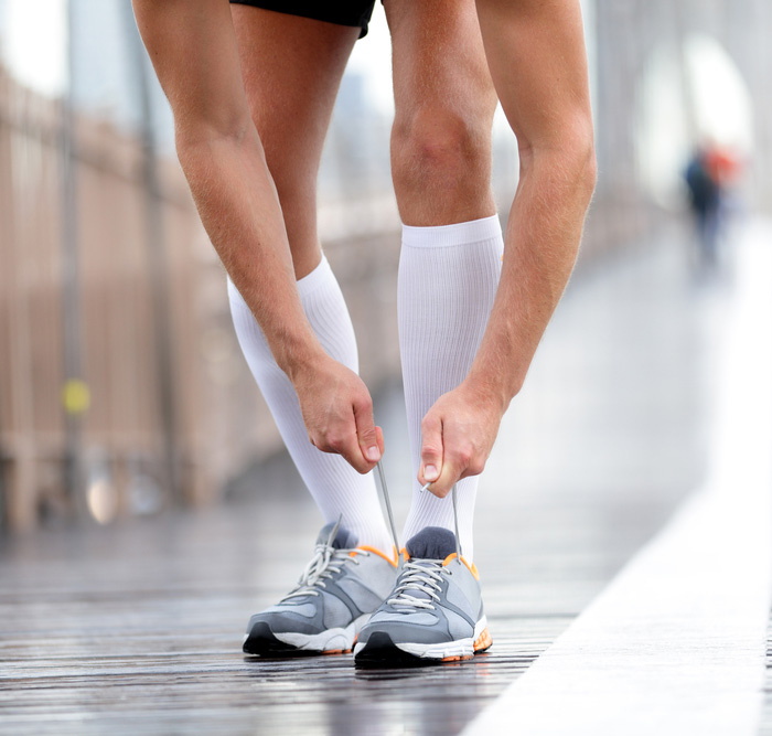 Male runner wearing white compression socks