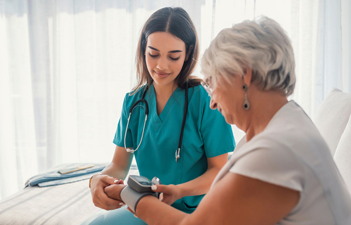 Nurse uses wrist blood pressure monitor