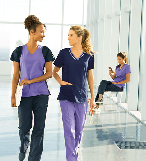 Nurses Walking Wearing Purple Barco Scrubs 