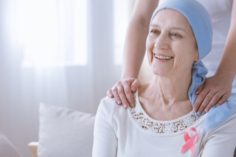 Patient wearing white shirt and awareness ribbon