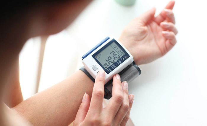 Female patient using wrist blood pressure monitor