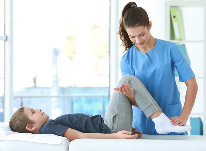physical therapist working with child