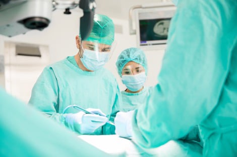 Surgical team wearing scrubs in hospital operating room
