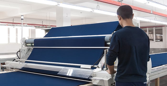 Man preparing cloth at a garment factory