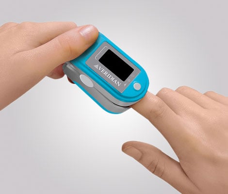 Finger pulse oximeter showing oxygen saturation percentage