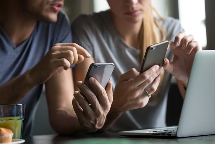 mom and dad coordinate family calendars on phones