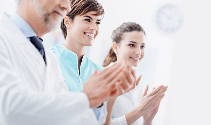 Doctors applauding white coat ceremony