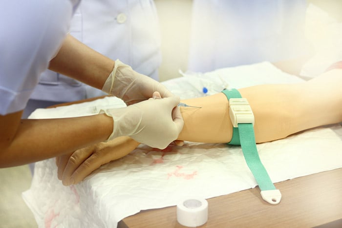 nurse draws patient blood