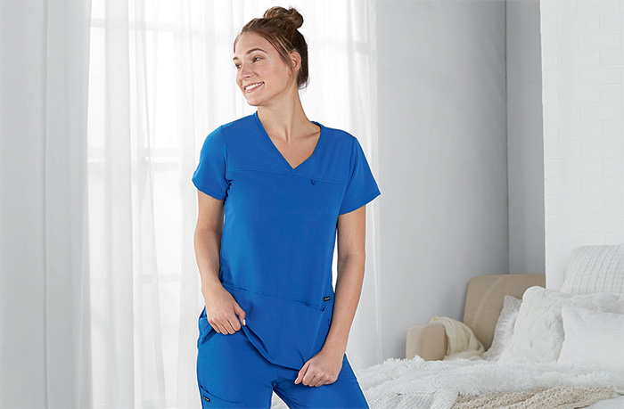 female nurse wearing jockey scrubs in bedroom