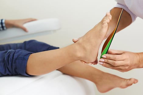 Patient being fitted for orthotic insoles