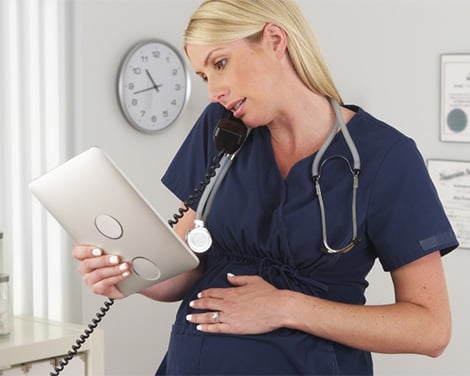 Pregnant nurse talking on the phone 