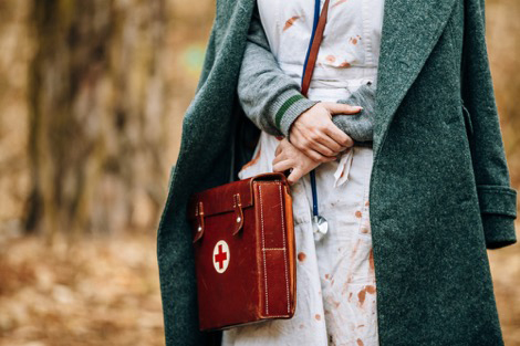 Female WWII reenactor wearing historical nursing uniform