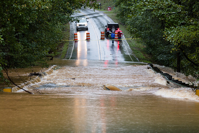 Motorists inspect a road flooded by rain from Hurricane Florence